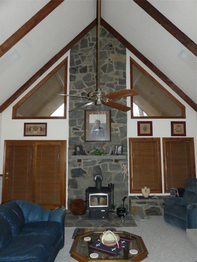 living room featuring high vaulted ceiling, beamed ceiling, carpet flooring, and a wood stove