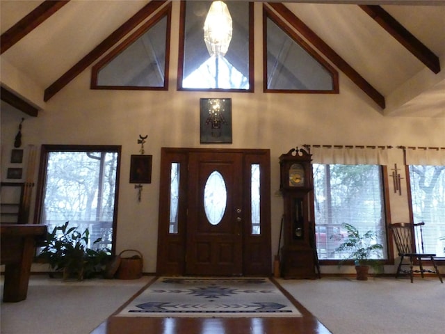 foyer entrance featuring high vaulted ceiling and beam ceiling