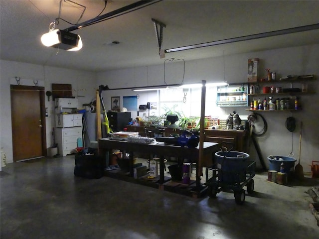 garage featuring a workshop area and a garage door opener