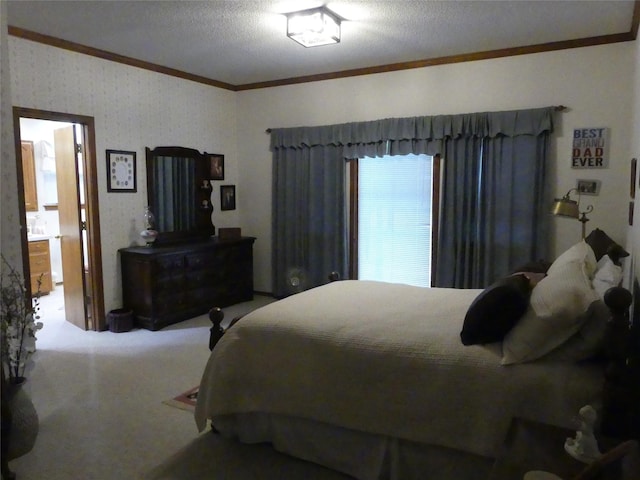 carpeted bedroom with ornamental molding and a textured ceiling