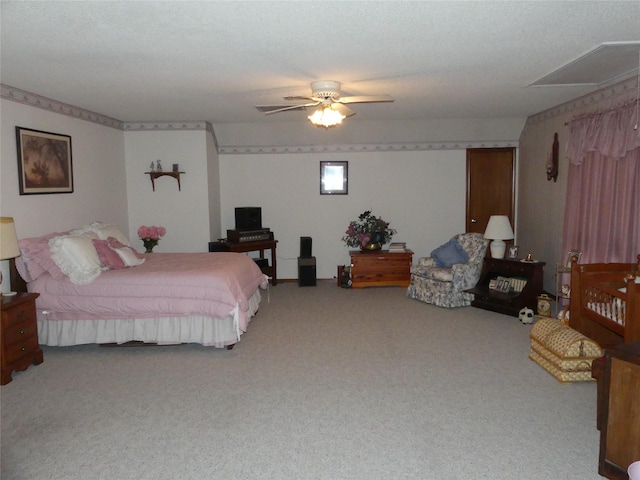 carpeted bedroom featuring a ceiling fan and a textured ceiling