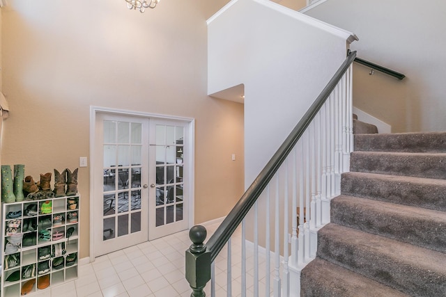 stairs featuring french doors, tile patterned floors, and ornamental molding