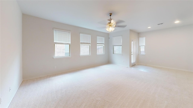 carpeted spare room featuring ceiling fan