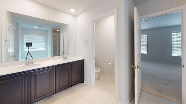 bathroom with walk in shower, tile patterned flooring, vanity, and toilet