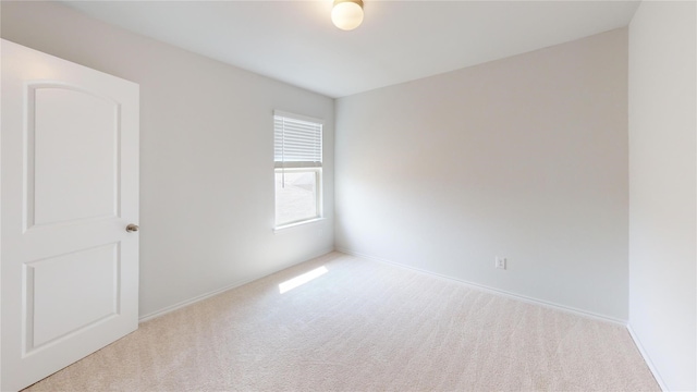 spare room with light colored carpet