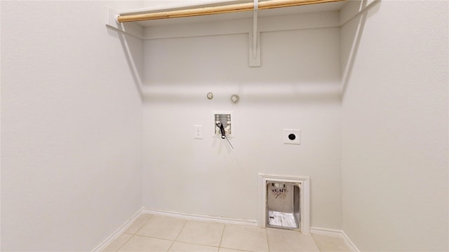 clothes washing area featuring gas dryer hookup, light tile patterned floors, washer hookup, and hookup for an electric dryer