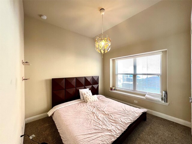 carpeted bedroom with lofted ceiling