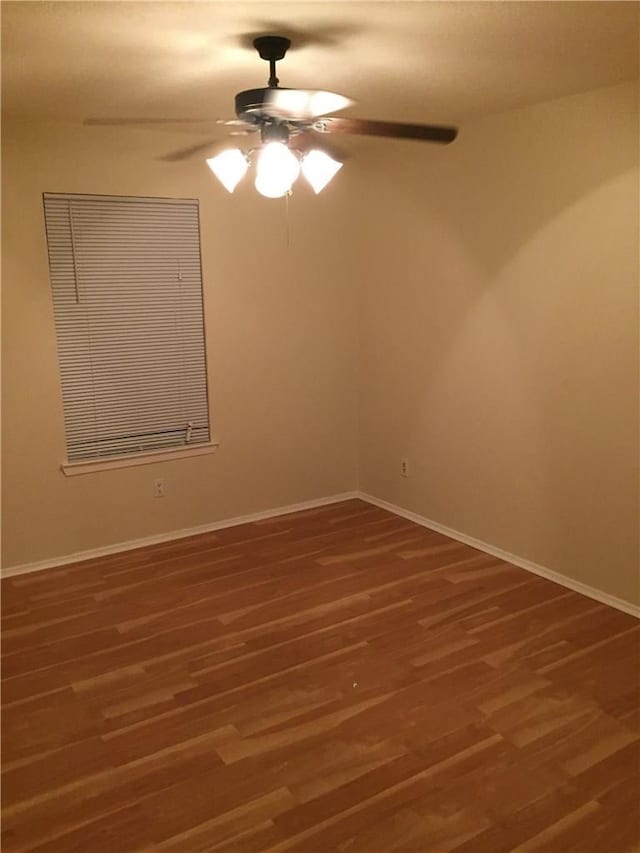 unfurnished room featuring ceiling fan and dark wood-type flooring