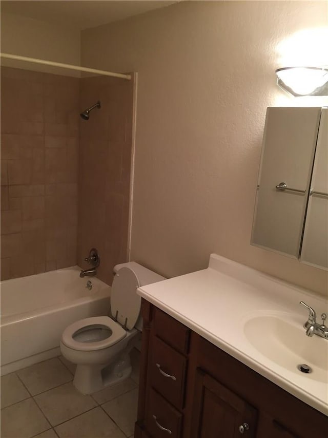 full bathroom featuring tile patterned flooring, vanity, toilet, and tiled shower / bath