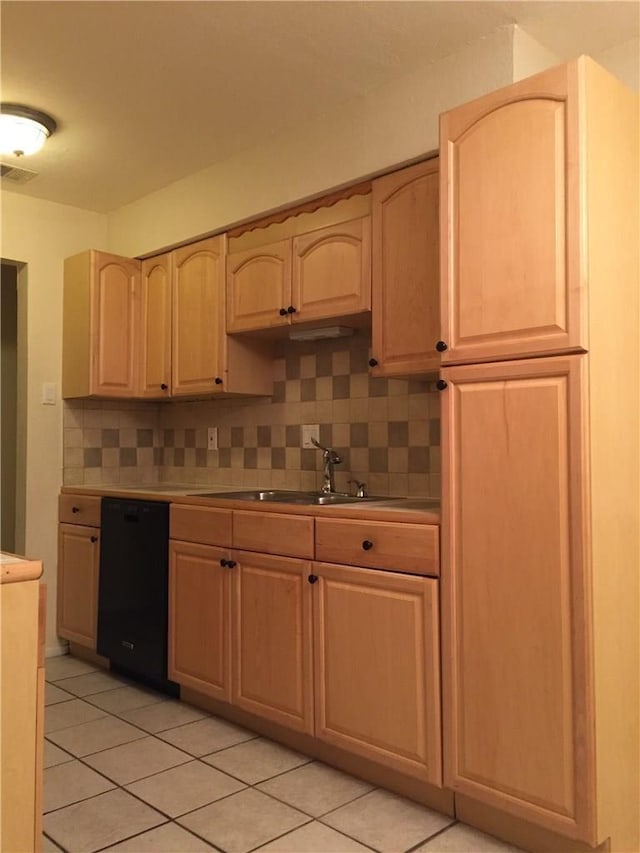 kitchen with backsplash, light tile patterned floors, black dishwasher, and light brown cabinetry