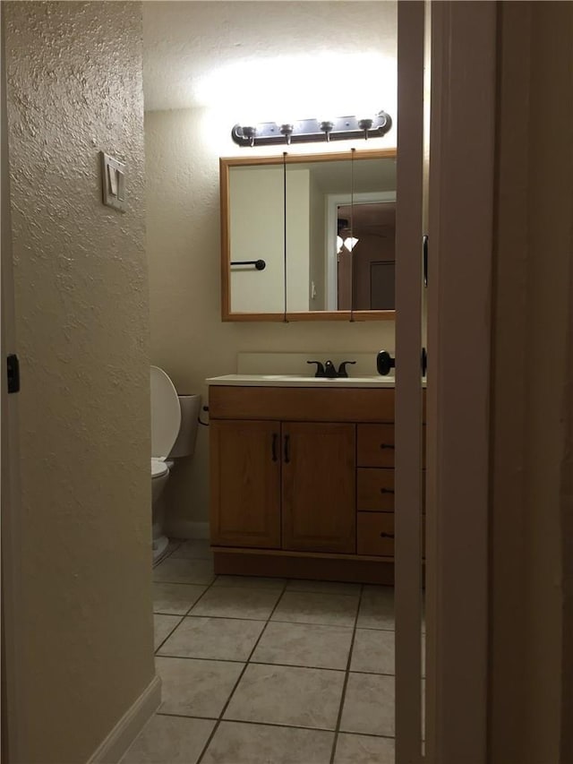 bathroom with tile patterned floors, vanity, and toilet