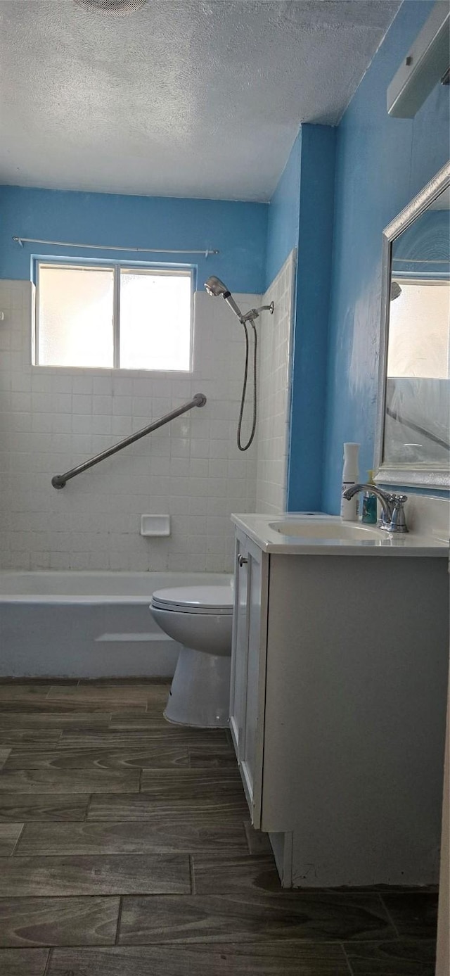 full bathroom with vanity, a healthy amount of sunlight, toilet, and wood-type flooring