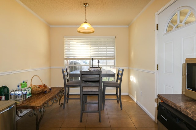 dining area with crown molding, tile patterned flooring, and a textured ceiling