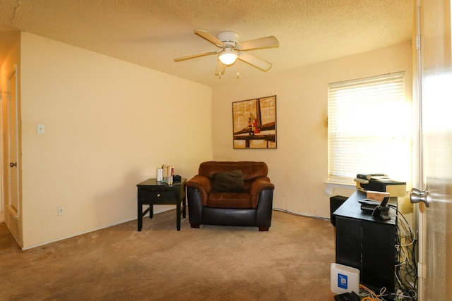 living area featuring a textured ceiling, light colored carpet, and ceiling fan