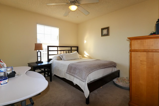 bedroom featuring a textured ceiling, carpet floors, and ceiling fan