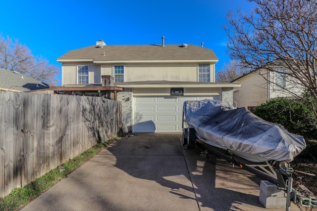 rear view of property with a garage