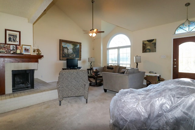 carpeted living room with ceiling fan and lofted ceiling