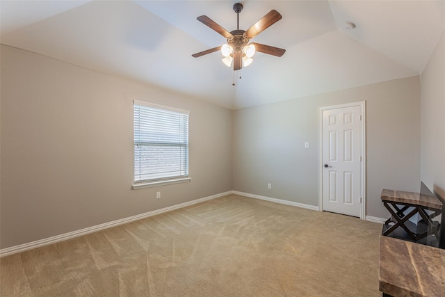 empty room with lofted ceiling, light carpet, and ceiling fan