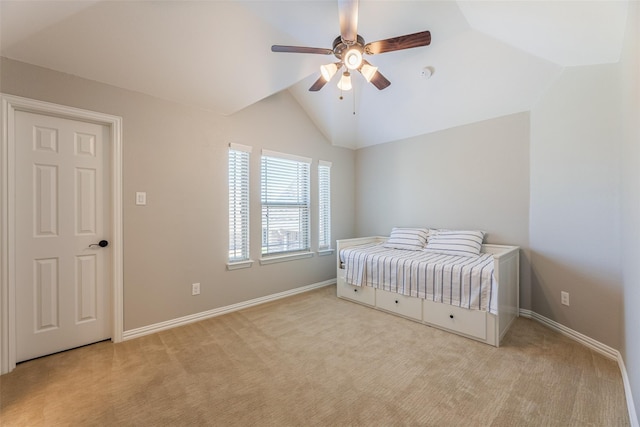 carpeted bedroom with ceiling fan and lofted ceiling