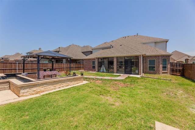 back of house with a gazebo and a yard