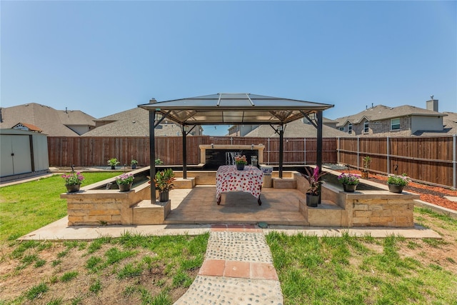 view of patio / terrace with a gazebo and a shed