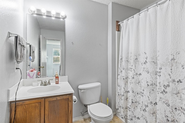 bathroom with vanity, a textured ceiling, toilet, and walk in shower