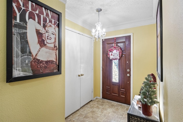 entryway featuring a chandelier, a textured ceiling, and ornamental molding