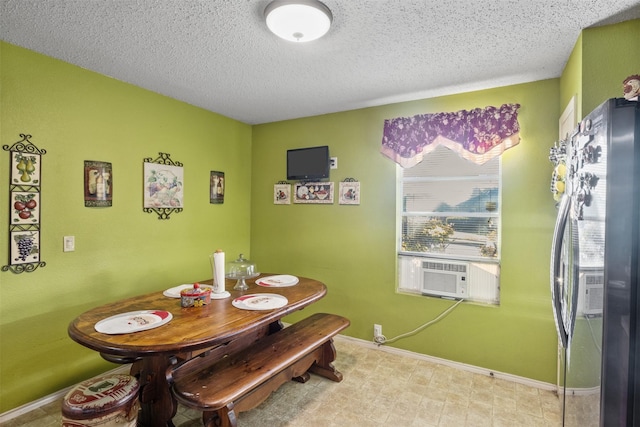 dining area featuring cooling unit and a textured ceiling