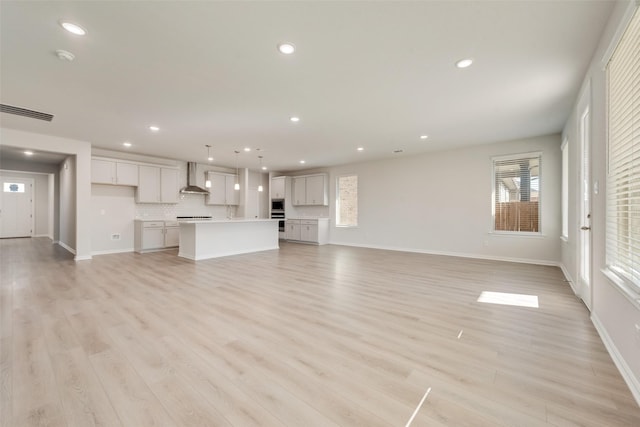 unfurnished living room featuring light hardwood / wood-style flooring