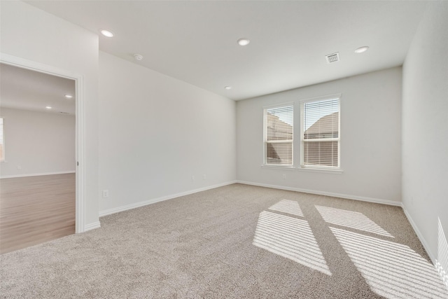 unfurnished room with light carpet