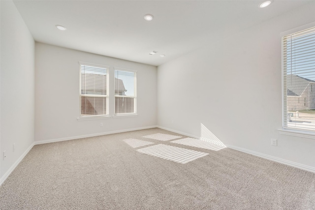 spare room featuring light colored carpet