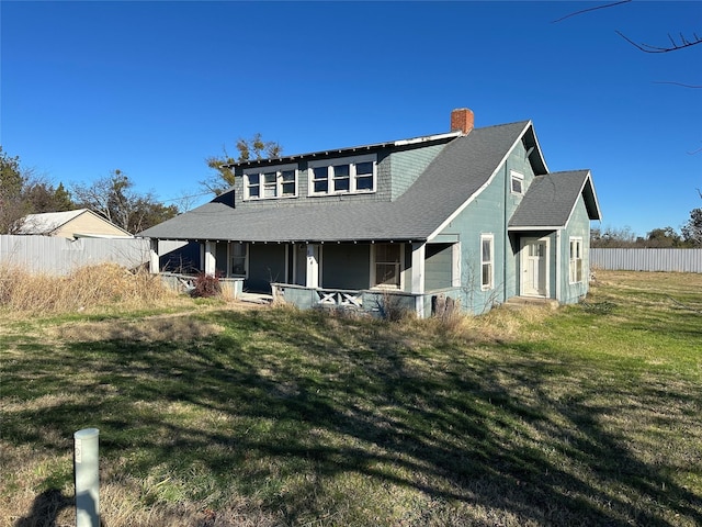 view of front of property with covered porch and a front yard