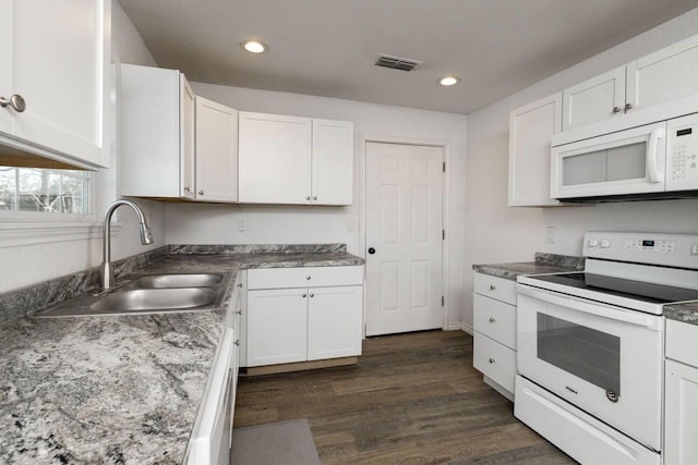 kitchen featuring white cabinets, dark hardwood / wood-style flooring, white appliances, and sink