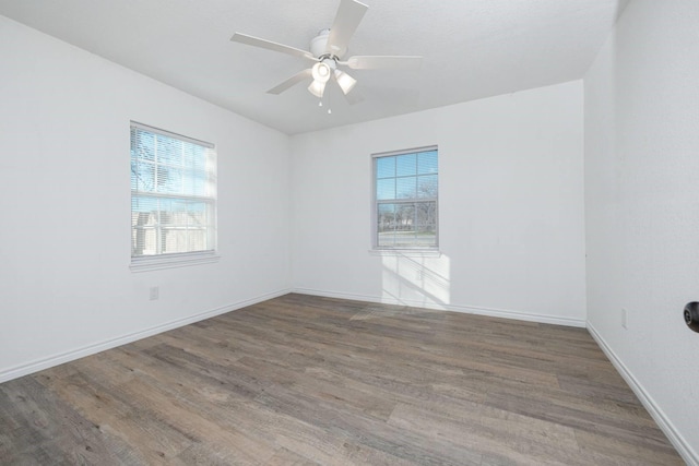 unfurnished room with ceiling fan and hardwood / wood-style flooring