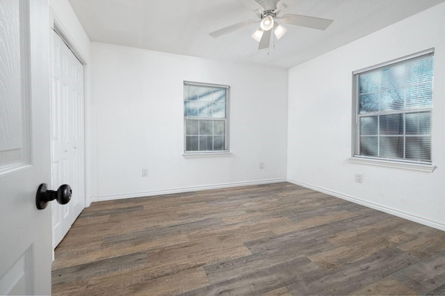 unfurnished room featuring dark hardwood / wood-style floors and ceiling fan