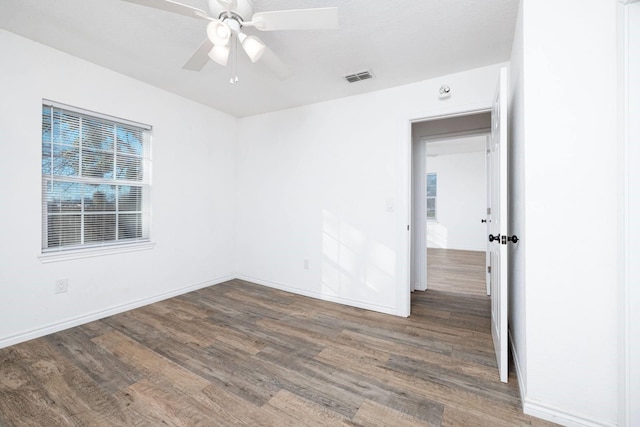 spare room featuring ceiling fan and dark hardwood / wood-style flooring