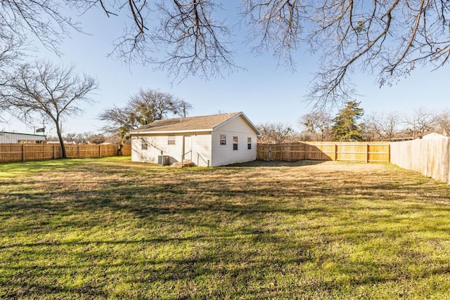 view of yard with central AC and an outdoor structure