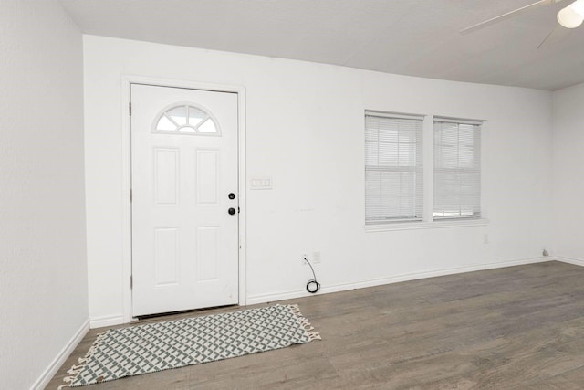 entryway with ceiling fan and dark wood-type flooring