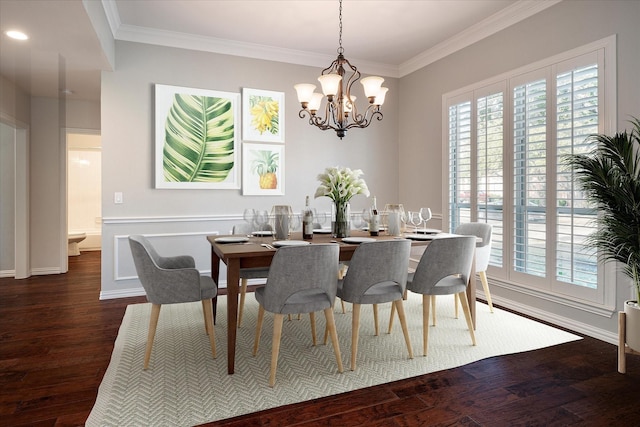 dining area featuring ornamental molding, a chandelier, and dark hardwood / wood-style flooring