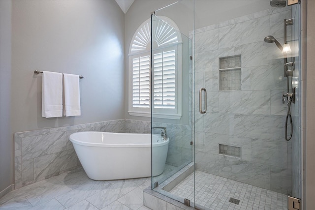 bathroom featuring separate shower and tub