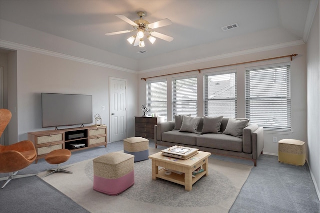 living room featuring ceiling fan, carpet, crown molding, and a raised ceiling