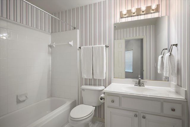 full bathroom featuring toilet, vanity, and tiled shower / bath combo