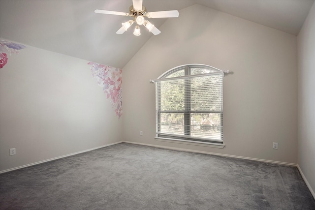 spare room featuring dark colored carpet, ceiling fan, and vaulted ceiling