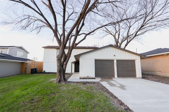 view of front of house featuring a garage and a front lawn