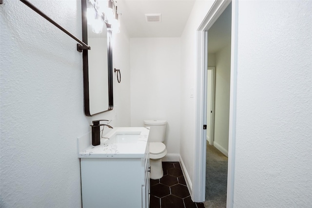 bathroom with vanity, tile patterned floors, and toilet