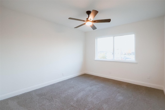 spare room featuring ceiling fan and carpet