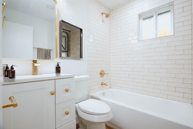 full bathroom with vanity, toilet, and tiled shower / bath