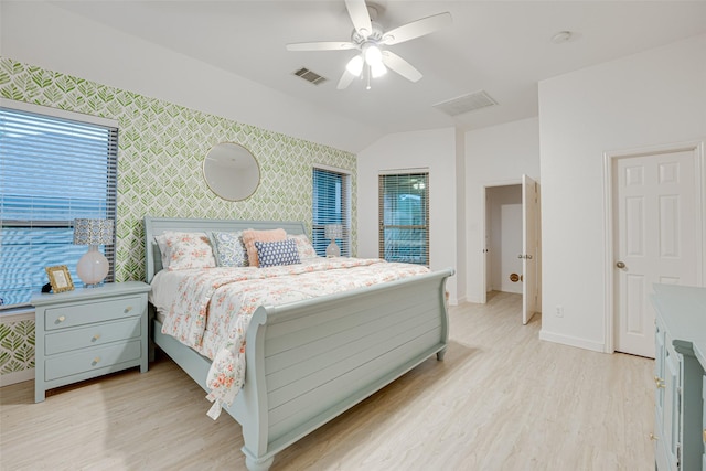 bedroom featuring ceiling fan, light hardwood / wood-style floors, and vaulted ceiling