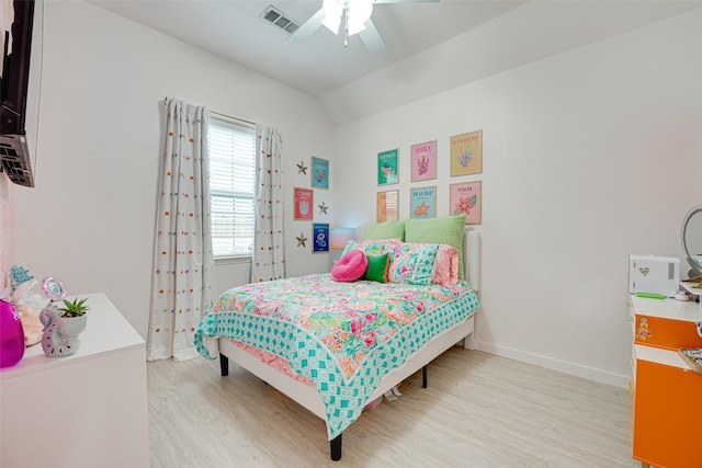 bedroom featuring light hardwood / wood-style floors, ceiling fan, and lofted ceiling