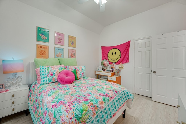 bedroom featuring ceiling fan, light hardwood / wood-style floors, and vaulted ceiling